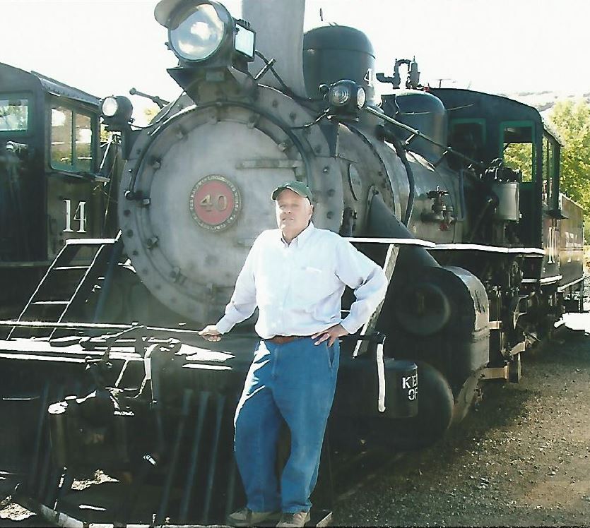 John Standing in Front of Locomotive
